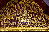 Wat Xieng Thong temple in Luang Prabang, Laos.  La Chapelle Rouge , the Red Chapel. Detail of the decoration of the pediment. 